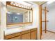 Bathroom with wood vanity, sink, and large mirror at 847 Lake Charm Dr, Oviedo, FL 32765
