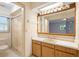 A bathroom with a shower and a vanity with a mirror at 847 Lake Charm Dr, Oviedo, FL 32765
