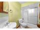 Clean bathroom with tub, toilet, and pedestal sink at 847 Lake Charm Dr, Oviedo, FL 32765