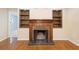A brick fireplace with a wood mantel and shelving at 847 Lake Charm Dr, Oviedo, FL 32765