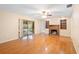 Spacious living room with hardwood floors and a brick fireplace at 847 Lake Charm Dr, Oviedo, FL 32765