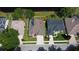 Aerial view of a home with a private pool and a pond view, surrounded by lush green lawns at 890 Moonluster Dr, Casselberry, FL 32707