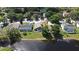 A serene aerial view of the home overlooking a peaceful pond and lush green surroundings at 890 Moonluster Dr, Casselberry, FL 32707