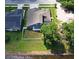 A beautiful aerial view of the house with a large backyard, fence, and access to a serene pond at 890 Moonluster Dr, Casselberry, FL 32707