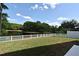 Spacious backyard with a well-maintained lawn and a serene pond view at 890 Moonluster Dr, Casselberry, FL 32707