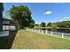 Backyard showcasing a screen-enclosed porch and pool area overlooking a serene lake, perfect for outdoor relaxation at 890 Moonluster Dr, Casselberry, FL 32707