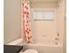 Bright bathroom featuring a tub with shower and a floral shower curtain at 890 Moonluster Dr, Casselberry, FL 32707