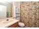 Hall bathroom featuring a single sink vanity, toilet, and shower with decorative floral shower curtain at 890 Moonluster Dr, Casselberry, FL 32707