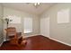 Cozy bedroom featuring a rocking chair, wood floors, and ample natural light at 890 Moonluster Dr, Casselberry, FL 32707