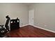 Bedroom featuring a desk, neutral paint, laminate floors, and base molding at 890 Moonluster Dr, Casselberry, FL 32707