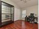 Bedroom featuring a display case, desk, window, laminate floors, and white closet doors at 890 Moonluster Dr, Casselberry, FL 32707