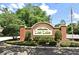 Attractive brick sign for Lost Lake community surrounded by mature trees and lush landscaping at 890 Moonluster Dr, Casselberry, FL 32707