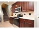 Kitchen featuring stainless steel oven and microwave, white countertops, and stairs to upper level at 890 Moonluster Dr, Casselberry, FL 32707
