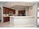 Stylish kitchen featuring modern appliances, wooden cabinets, and a breakfast bar for casual dining at 890 Moonluster Dr, Casselberry, FL 32707