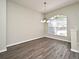 Bright living room featuring wood-look flooring, arched windows, and abundant natural light at 890 Moonluster Dr, Casselberry, FL 32707