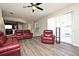 Open-concept living room with modern flooring, ceiling fan and access to kitchen and pool area at 890 Moonluster Dr, Casselberry, FL 32707