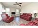 Comfortable living room showcasing modern flooring, a ceiling fan, and plenty of natural light at 890 Moonluster Dr, Casselberry, FL 32707