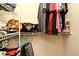Spacious closet with hanging rods and shelves stocked with clothing, shoes, and bags at 890 Moonluster Dr, Casselberry, FL 32707