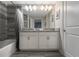 Double vanity, granite countertop, and a bathtub at 9043 Dogleg Dr, Davenport, FL 33896
