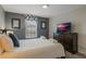 Bright bedroom featuring a queen bed, TV, and window seating at 9043 Dogleg Dr, Davenport, FL 33896