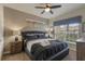 Spacious main bedroom with a king-size bed and ceiling fan at 9043 Dogleg Dr, Davenport, FL 33896