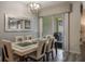 Bright dining room with modern chandelier and glass-top table at 9043 Dogleg Dr, Davenport, FL 33896