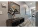 Modern entryway with dark wood console table and tasteful decor at 9043 Dogleg Dr, Davenport, FL 33896