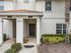 Townhome entryway with a dark brown console table and mirror at 9043 Dogleg Dr, Davenport, FL 33896
