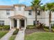 Two-story townhome with attractive landscaping and a tiled roof at 9043 Dogleg Dr, Davenport, FL 33896