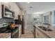 Modern kitchen with stainless steel appliances and granite countertops at 9043 Dogleg Dr, Davenport, FL 33896
