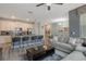 Open floor plan boasts a spacious kitchen with island and a cozy living room at 9043 Dogleg Dr, Davenport, FL 33896