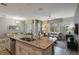 Open floor plan with kitchen island, granite counters, and living area at 9043 Dogleg Dr, Davenport, FL 33896