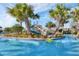 Resort-style pool with waterslide and palm trees at 9043 Dogleg Dr, Davenport, FL 33896