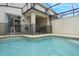 Private screened-in pool with patio access from sliding glass doors at 9043 Dogleg Dr, Davenport, FL 33896