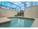 Enclosed private pool area with lounge chairs and a screened enclosure at 9043 Dogleg Dr, Davenport, FL 33896