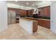 Gourmet kitchen featuring wood cabinetry, granite countertops, and island at 100 S Virginia Ave # 401, Winter Park, FL 32789