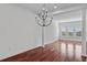 Elegant living room featuring hardwood floors, a chandelier, and classic columns at 100 S Virginia Ave # 401, Winter Park, FL 32789