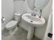Clean bathroom with pedestal sink, toilet and tiled floor at 10432 Austrina Oak Loop, Winter Garden, FL 34787