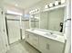 Double vanity bathroom with a walk-in shower and tiled floors at 10432 Austrina Oak Loop, Winter Garden, FL 34787