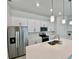 Modern kitchen with white cabinets, quartz countertops and stainless steel appliances at 10432 Austrina Oak Loop, Winter Garden, FL 34787