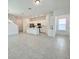 Open concept kitchen with white cabinets, island, and stainless steel appliances at 10432 Austrina Oak Loop, Winter Garden, FL 34787