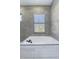Modern bathroom with a free-standing bathtub and a window at 10483 Kristen Park Dr, Orlando, FL 32832