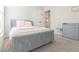Spacious bedroom with gray upholstered bed and pink accents at 10483 Kristen Park Dr, Orlando, FL 32832