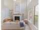 Light-filled living area with a cozy fireplace and hardwood floors at 10483 Kristen Park Dr, Orlando, FL 32832
