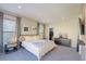 Main bedroom with large bed and wood feature wall at 10483 Kristen Park Dr, Orlando, FL 32832