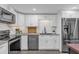 Modern kitchen with white cabinets, stainless steel appliances, and granite countertops at 1098 S Oleander St, Longwood, FL 32750