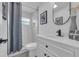 Modern bathroom with white vanity, marble shower, and gray accents at 1203 Marlowe Ave, Orlando, FL 32809