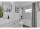 Modern bathroom with white vanity, bathtub, and gray tile at 1203 Marlowe Ave, Orlando, FL 32809