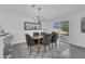 Bright dining room with modern table and chairs, chandelier, and view to backyard at 1203 Marlowe Ave, Orlando, FL 32809