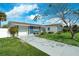 Front view of a remodeled home with a driveway and attached garage at 1203 Marlowe Ave, Orlando, FL 32809